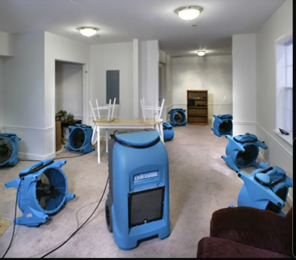 Air movers and dehumidifier setup for Water Damage Restoration in Genoa